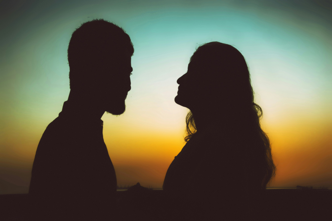 Happy couple looking at the sunset together