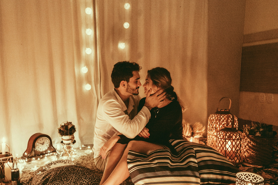 Young couple enjoying a romantic evening together at home with wine
